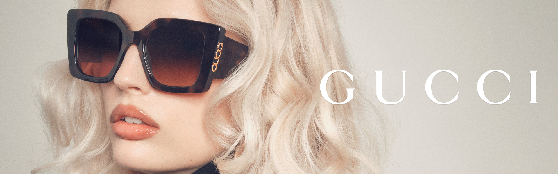Gucci sunglasses featured in a luxury campaign banner showcasing oversized designer frames